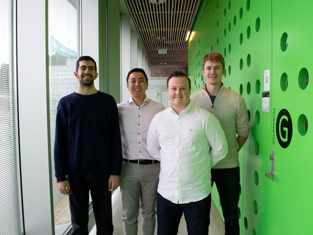 The four project members Kubilay Kerim Øzdemir, Zachary Rotea Laguda, Kasper Iversen and Håvard Solheim Jenssen stands on a row. 