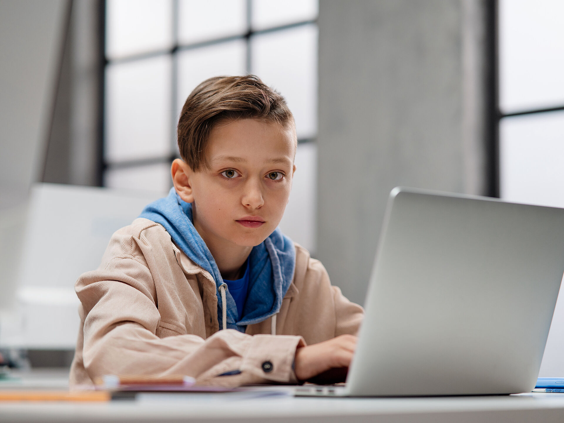 Bildet viser en ung gutt foran en pc-skjerm