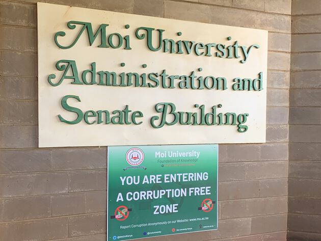 The picture shows the sign of Moi University.